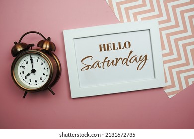 Hello Saturday And Alarm Clock On Pink Background