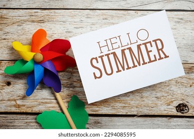 Hello Summer text message with windmill on wooden background - Powered by Shutterstock