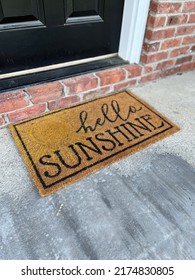 Hello Sunshine Door Mat Sitting On Front Porch Of House.