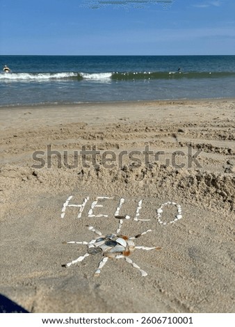 Hello sunshine made out of seashells on the beach in summer 