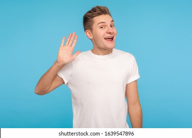 Hello, welcome! Portrait of funny happy hospitable man in casual white t-shirt waving hand to camera and smiling with friendly amiable expression. indoor studio shot isolated on blue background - Shutterstock ID 1639547896