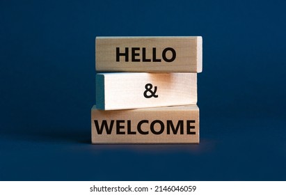 Hello and welcome symbol. Concept words Hello and welcome on wooden blocks. Beautiful grey background. Business hello and welcome concept. Copy space.