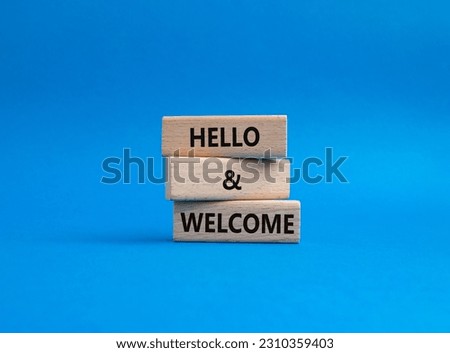 Hello and Welcome symbol. Concept words Hello and Welcome on wooden blocks. Beautiful blue background. Business and Hello and Welcome concept. Copy space.