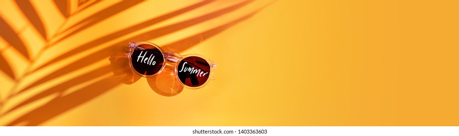 Hello Yellow Summer Sunglasses On Sunshine With Palm Leaf Plant Shadows With Summer Sunglasses On Background In Sunlight In Holiday Vacation.banner Copy Space For Display Of Design.minimal Youth Style