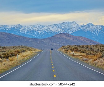 Hell's Canyon Scenic Byway. One Car In The Distance That's Leaving Baker City, Oregon Heading Into The Beautiful Wallowa Mountains On Cold November Day On State Route 86.