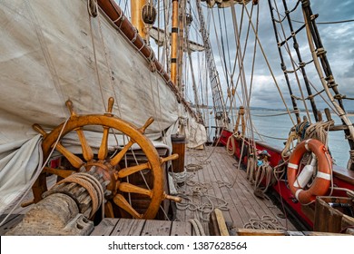 helm or rudder of a sailboat or deck of a sailboat with all the ropes ,sails ,helm or steering wheel of a sailboat