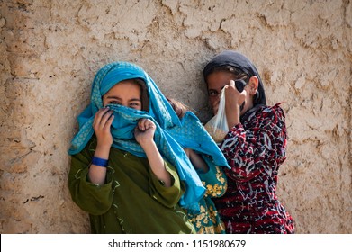 Helmand, Afghanistan May 2011 - Afghan Girls Hald Hide Away From The Camera