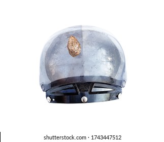 Helmet pierced by a stone on white background. Safety and road accidents