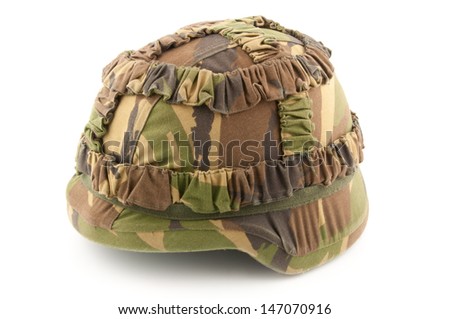 A helmet of a soldier with Dutch woodland camouflage