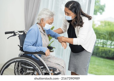 Help Asian Senior Or Elderly Old Lady Woman Sitting On Wheelchair And Wearing A Face Mask For Protect Safety Infection Covid-19 Coronavirus.