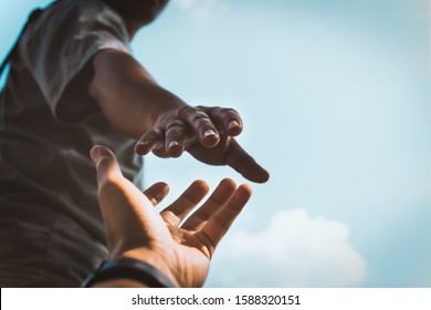 Help Concept hands reaching out to help each other in dark tone. - Shutterstock ID 1588320151