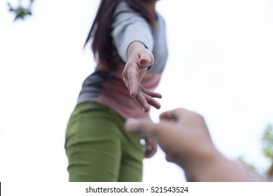 Help Concept Hands reaching out to help each other. - Shutterstock ID 521543524