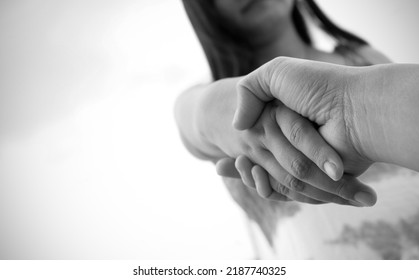 Help Concept Woman Hands Reaching Out To Help Other In Black And White