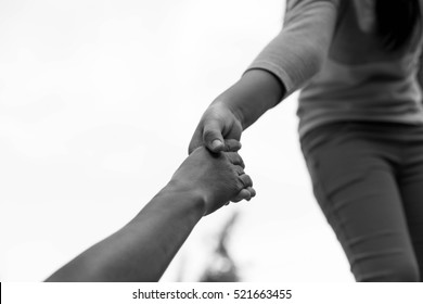 Help Concept Woman Hands Reaching Out To Help Other In Black And White