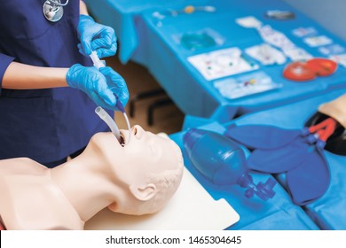 Help Emergency With Complications In The Respiratory Tract.. Introduction Endotracheal Tube (ETT) Into Trachea Ensure Airway Patency. Female Medical Student Performs Procedure Exam. CMYK