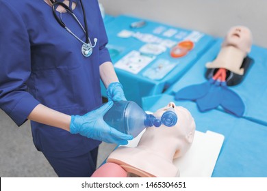 help emergency with complications in the respiratory tract.. introduction endotracheal tube (ETT) into trachea ensure airway patency. female medical student performs procedure exam. CMYK