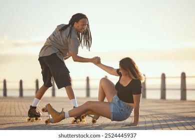 Help, falling and couple roller skating and holding hands at the beach in summer for a fun and healthy cardio activity. Friends love to skate and exercise on sidewalk as girl falls on the ground - Powered by Shutterstock