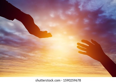 Help hand concept on sunset background