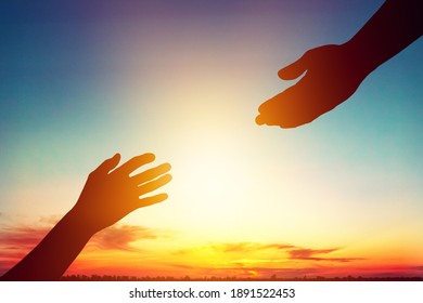 Help hand concept on sunset background
