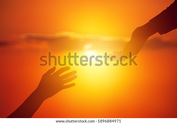 Help hand concept on\
sunset background