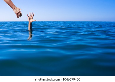 Help hand for drowning man life saving in sea or ocean.