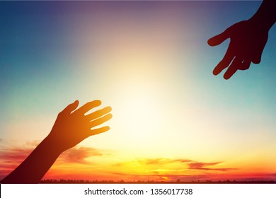 Help hand on sunset background