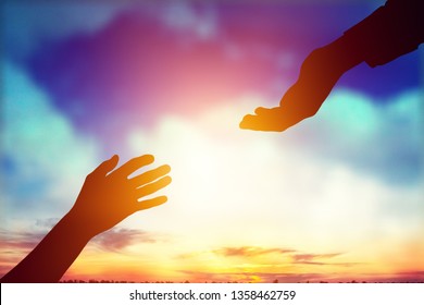 Help hand on sunset background - Shutterstock ID 1358462759
