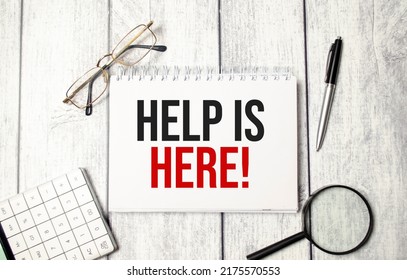 Help Is Here Words On Notepad And Pen, Calculator And Glasses