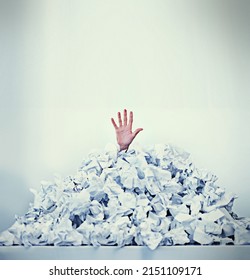 Help Im drowning in paperwork. Cropped shot of a businessman buried under a pile of crumpled up paperwork.