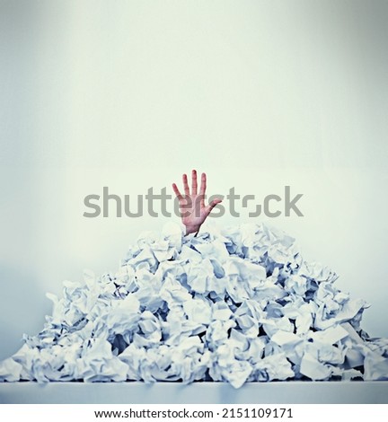 Help Im drowning in paperwork. Cropped shot of a businessman buried under a pile of crumpled up paperwork.
