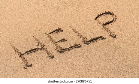 Help Sign Drawn On Beach Sand