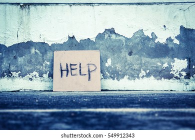 Help Sign Paper On The Grungy Wall,poverty Concept And Ideas