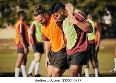 Help, soccer and a man with an injury on the field after a fitness or sports accident. Medical, training and friends or team with support for an athlete with a football emergency, pain or hurt muscle - Powered by Shutterstock