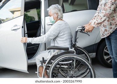 Help and support asian senior or elderly old lady woman patient sitting on wheelchair prepare get to her car, healthy strong medical concept.