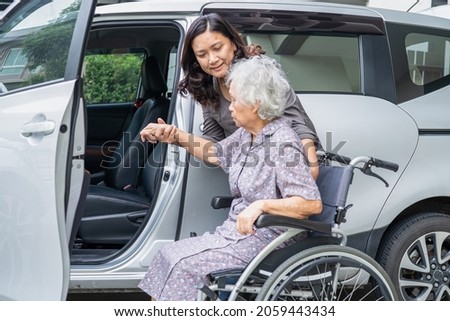 Help and support asian senior or elderly old lady woman patient sitting on wheelchair prepare get to her car, healthy strong medical concept.