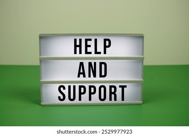 Help And Support text on light box on green background