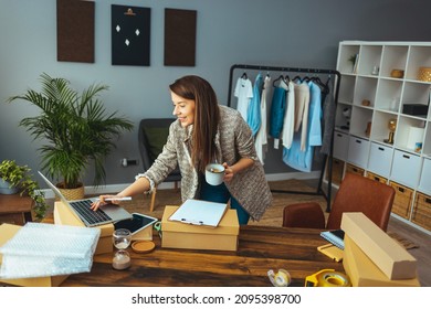 Help Of Technology In Delivery Business. Working Woman At Online Shop. She Wearing Casual Clothing And Checking On Laptop Address Of Customer And Package Information