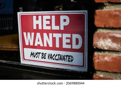 Help Wanted But Must Be Vaccinated Sign In Business Window