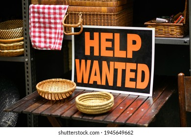 Help Wanted Sign Displayed In A Shop Selling Woven Baskets In A Job Vacancy, Hiring And Employment Concept