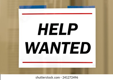 Help Wanted Sign Taped To Business Door