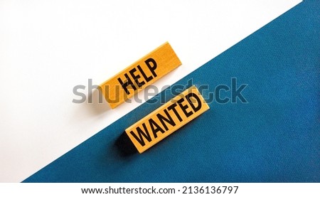 Help wanted and support symbol. Concept words Help wanted on wooden blocks on a beautiful blue table white background. Business support and help wanted concept, copy space.