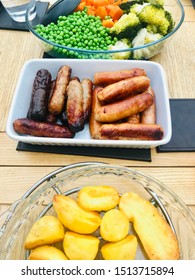 Help Yourself To Sunday Roast Dinner With Sausages, Mixed Vegetables And Roast Potatoes