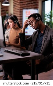 Helpdesk Assistant Working At Call Center Client Care On Phone Line, Using Telemarketing Equipment. Customer Service Operator Giving Support And Assistance On Helpline Telephony Network.