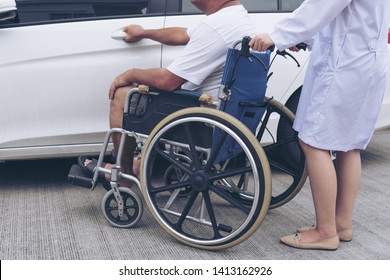  Helpful Female Nurse With Old Man On Wheelchair Helping He Get In To The Car 