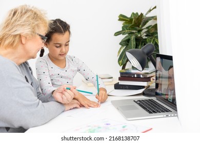 Helpful Granny. Helpful Loving Granny Assisting Her Cute Granddaughter Making Homework