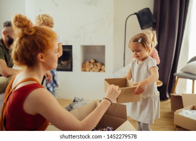 So Helpful. Nice Pretty Girl Bringing A Box To Her Mother While Wanting To Help Her