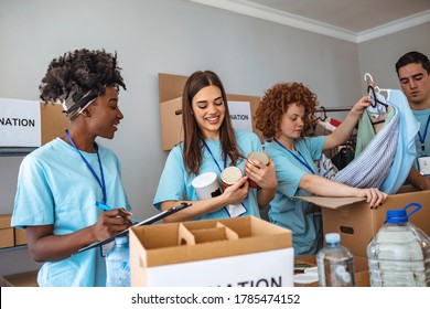 Helpful team of social workers. Group of mixed race people working in charitable foundation. Somebody's little is someone's everything. Young people sorting donations - Shutterstock ID 1785474152