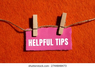 Helpful tips message written on ripped torn paper background. Conceptual Helpful tips symbol. Copy space.
