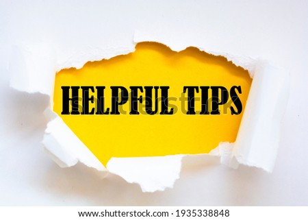 HELPFUL TIPS text written under torn paper.