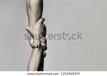 Helping hand concept and international day of peace, support. Helping hand outstretched, isolated arm, salvation. Close up help hand. Two hands, helping arm of a friend, teamwork. Black and white.